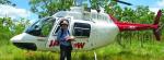 An SRK consultant next to a helicopter at a site visit